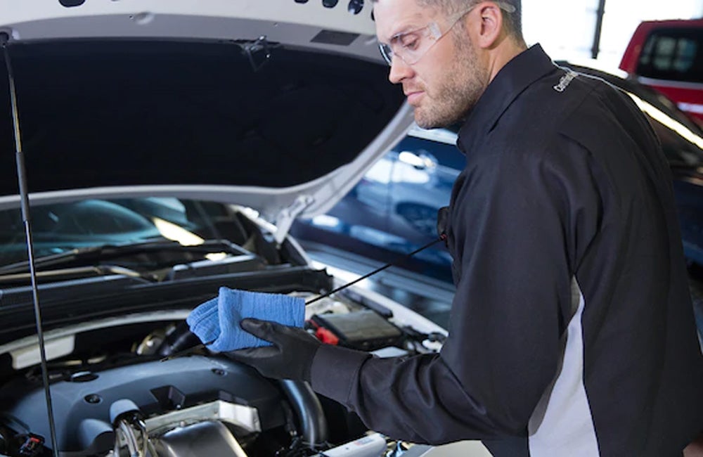 Mechanic checking oil